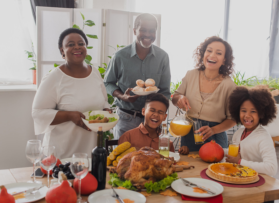 Personal Insurance - Cheerful Family Celebrating Thanksgiving Near Food at Home