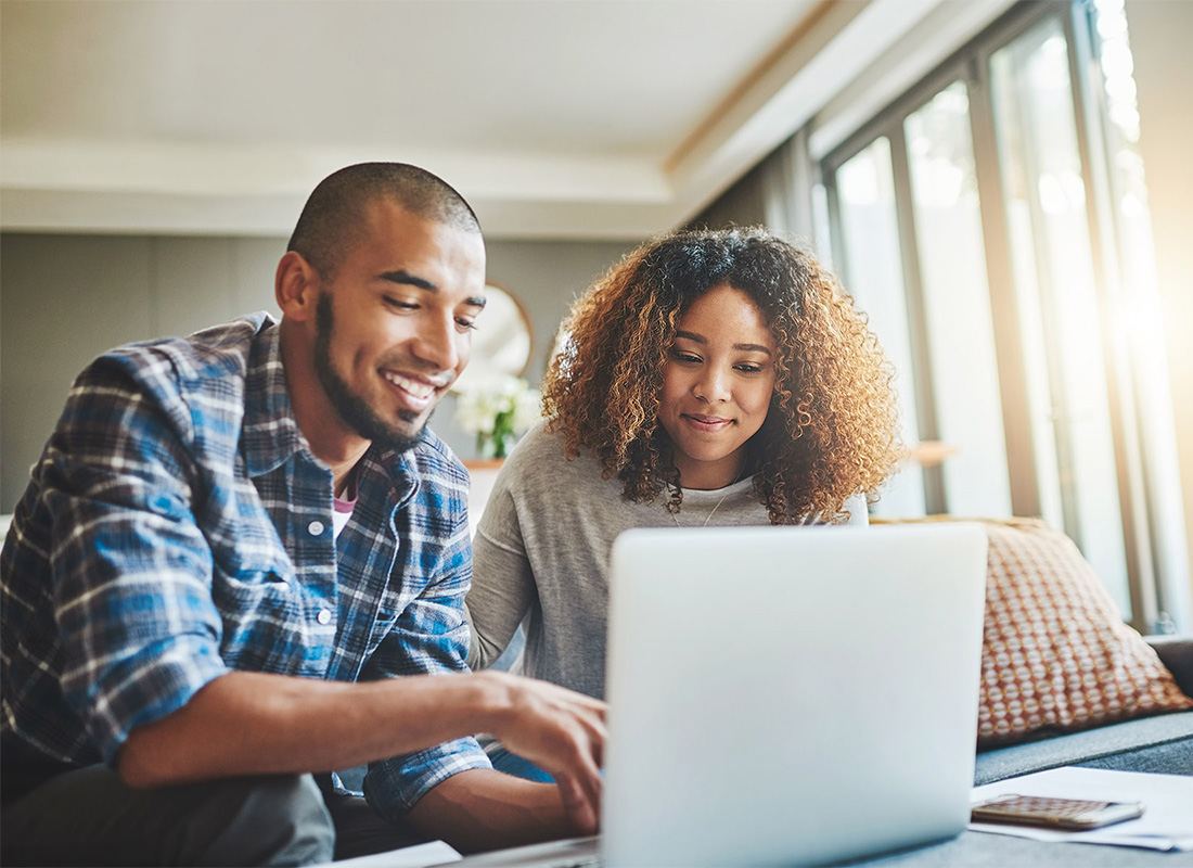 Read Our Reviews - Young Couple Working Together While Using a Laptop